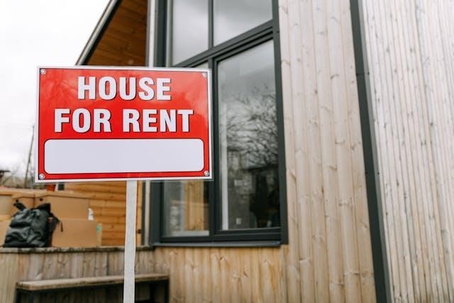 House for rent sign in front of a out